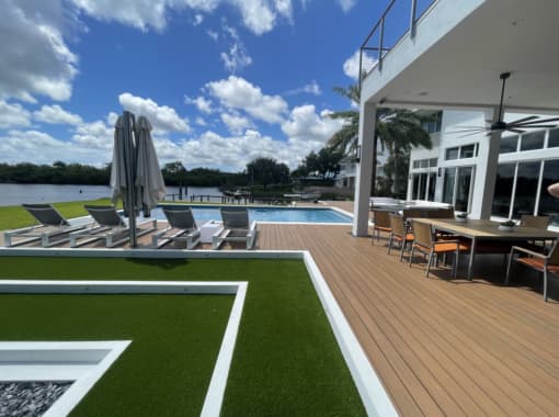 Custom in ground pool with wood plank patio from CoastLife Pools in South Florida