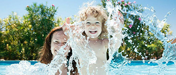 Man in black shirt standing next to girl in white shirt with arms crossed