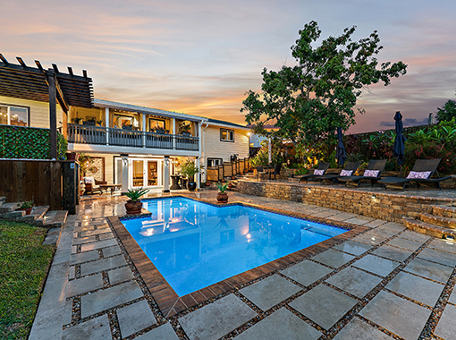 Custom in ground pool with stone tile patio from CoastLife Pools in South Florida