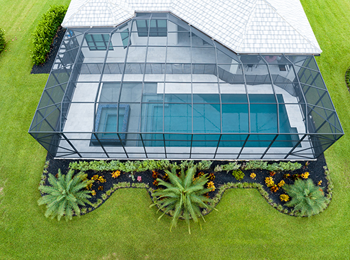 Custom in ground pool and hot tub inside screened in patio from CoastLife Pools South Florida